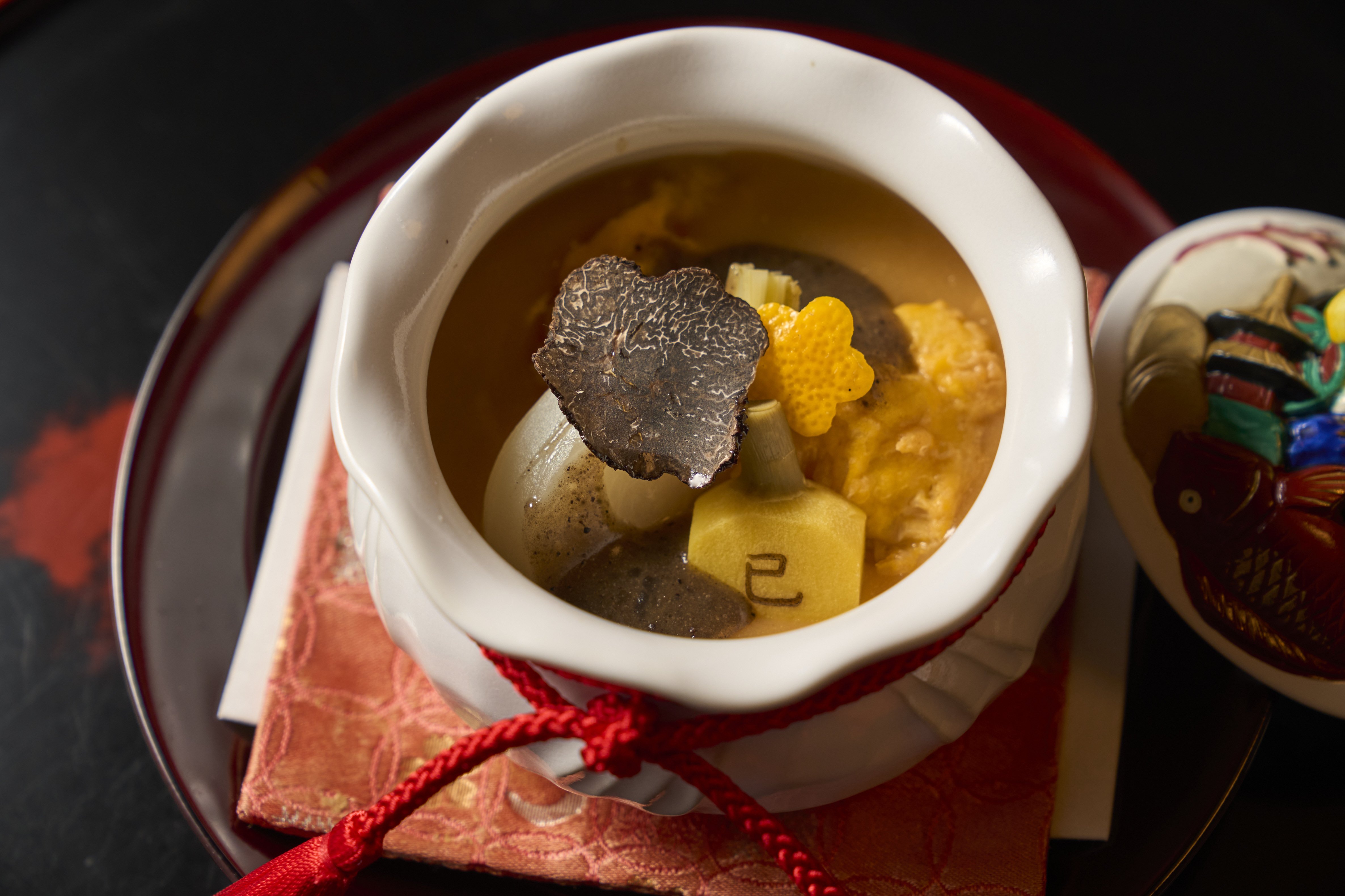 The shiizakana dish: kuwai (Japanese root vegetable) in the shape of ema (wooden plaques used to make a wish), topped with truffles.