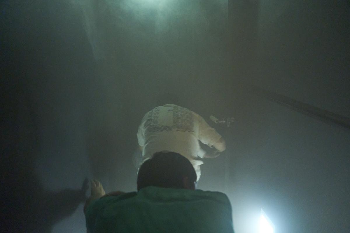 Participants practice evacuating from a dark, smoky room.