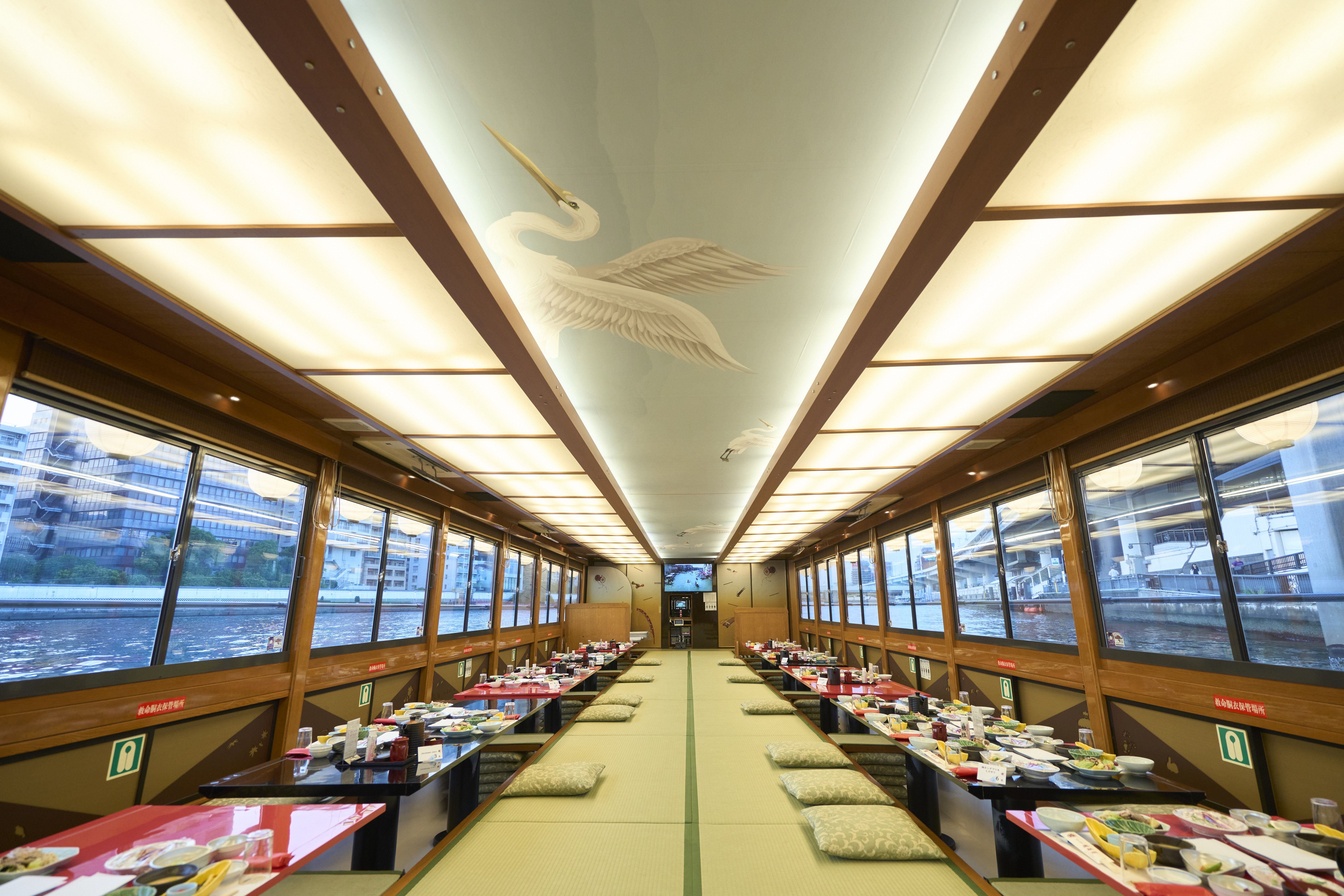 Tatami mats and low tables with sunken floors characterize the yakatabune's Japanese-style seating.