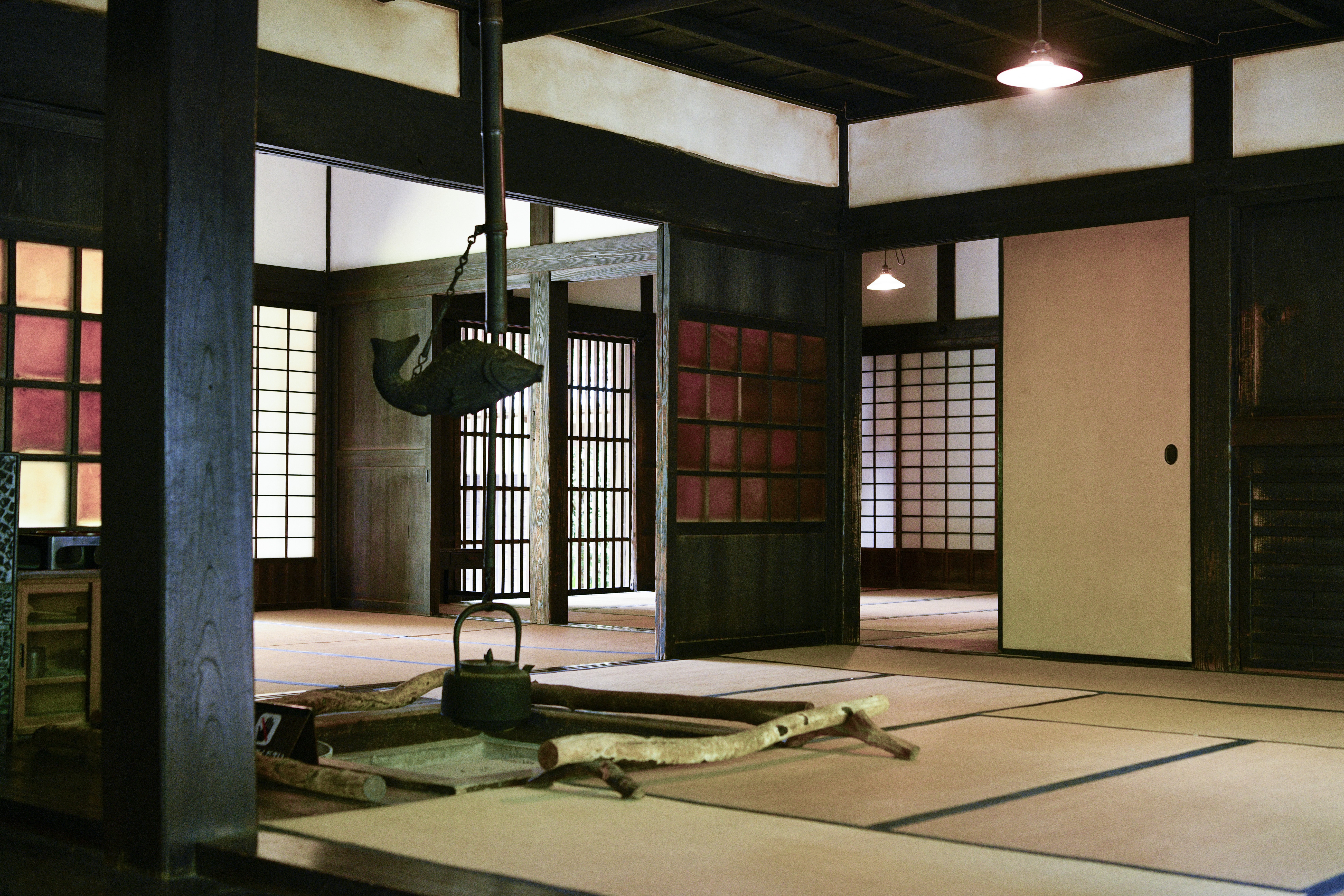 The farmhouse of the Tenmyo family has a living room with a traditional sunken hearth.