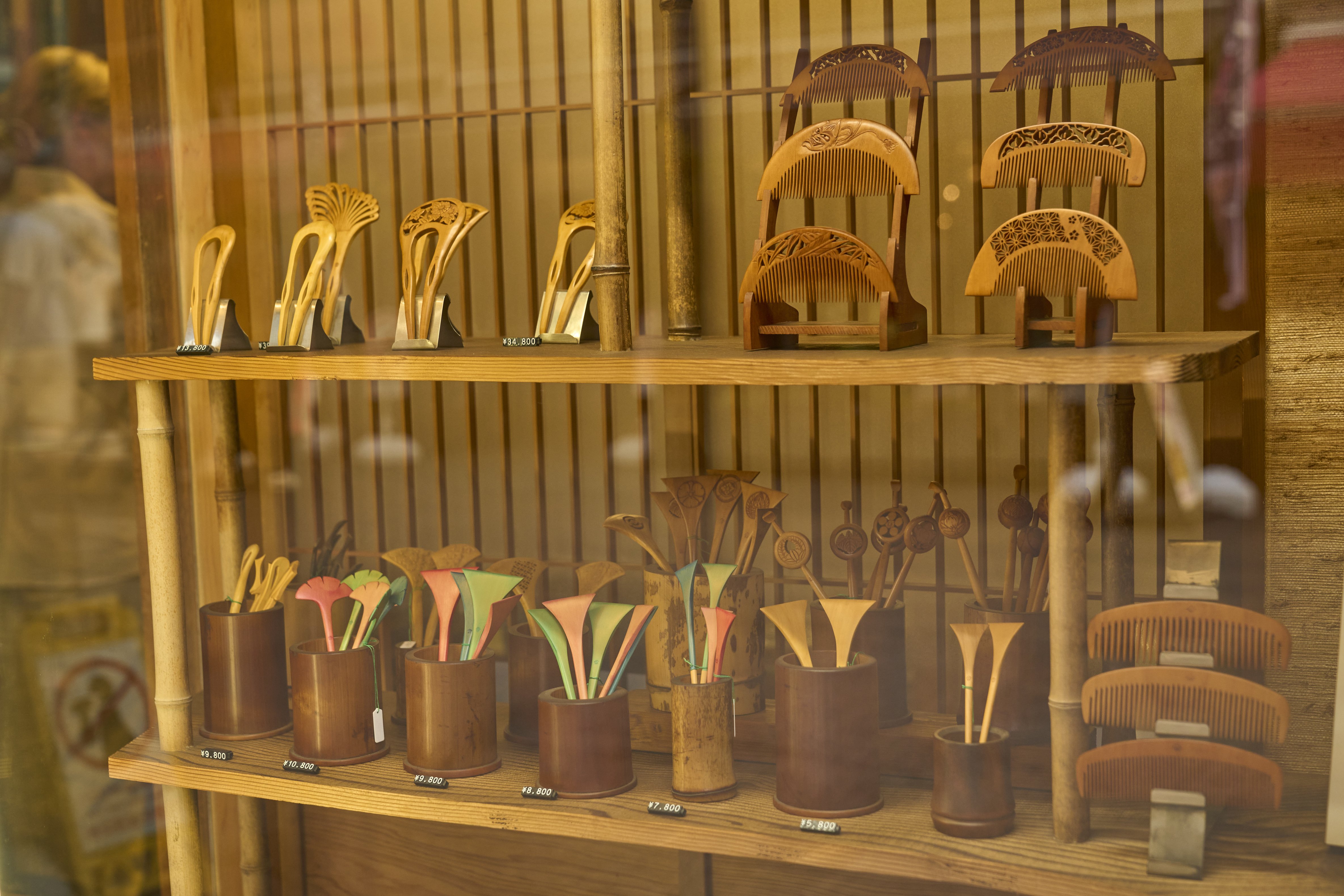 An array of combs and kanzashi hair ornaments in a variety of colors and styles, showcasing the artistry of Yonoya's workshop.
