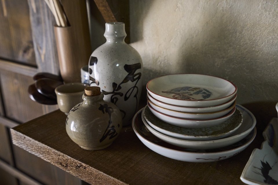 The tableware was selected from antique shops and other sources to reflect items used at the time.